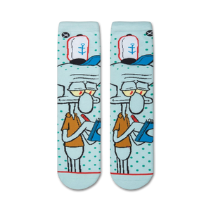 A close up of a pair of socks with a light blue background and a cartoon character with black outlines and red and yellow details.