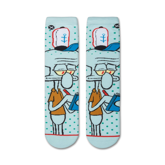 A close up of a pair of socks with a light blue background and a cartoon character with black outlines and red and yellow details.