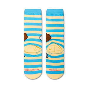 A close up of a pair of socks with a pattern of Sandy Cheeks from the cartoon Spongebob Squarepants. Sandy is smiling with her arms in the air. The socks are blue and white striped with a yellow toe and heel.