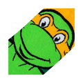 Close-up detail shot of Michelangelo's face on the TMNT crew socks, showing the texture and quality of the print.