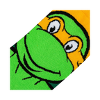 Close-up detail shot of Michelangelo's face on the TMNT crew socks, showing the texture and quality of the print.