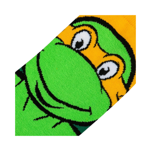 Close-up detail shot of Michelangelo's face on the TMNT crew socks, showing the texture and quality of the print.