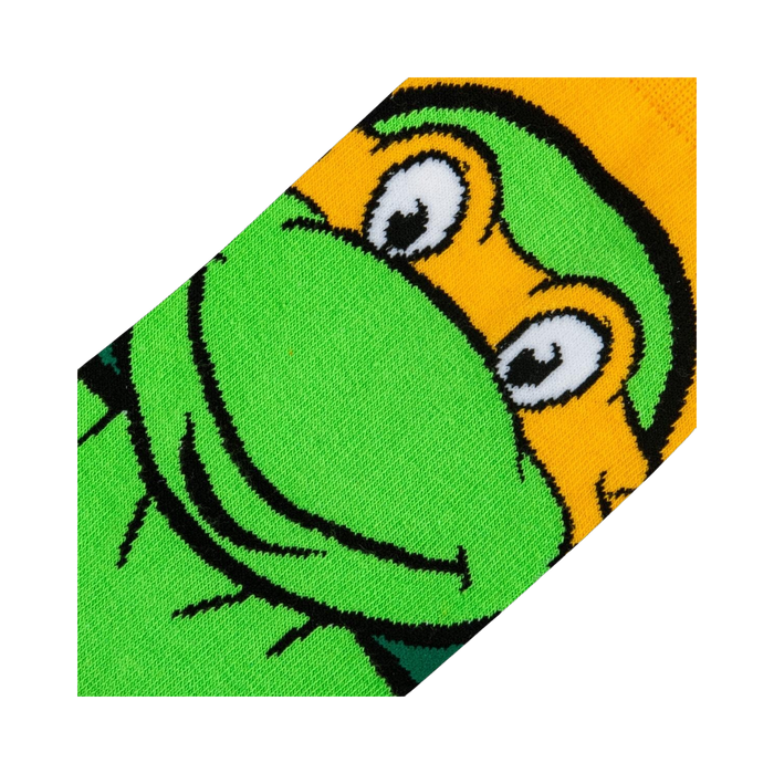 Close-up detail shot of Michelangelo's face on the TMNT crew socks, showing the texture and quality of the print.