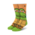 Crew socks featuring Michelangelo from TMNT. Green, orange, and brown colors.  Mikey's face and shell are prominently displayed.