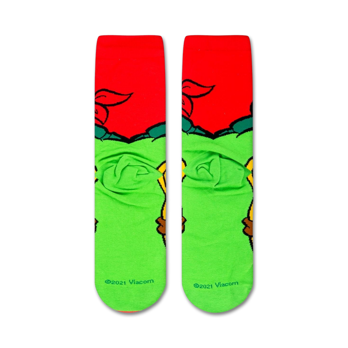 A pair of green and red socks with the Teenage Mutant Ninja Turtles on them.