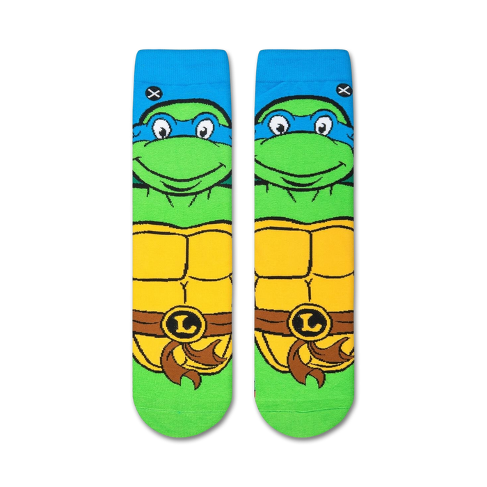 A close up of a pair of socks with the face of Leonardo from Teenage Mutant Ninja Turtles. Leonardo is a green turtle with blue eyes and a blue mask.