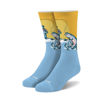 light blue fishing crew socks feature a fisherman wearing a red hat and blue overalls standing in a river fishing, with the word "cool" on the bottom.  