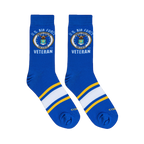 Flat lay of royal blue crew socks showing the U.S. Air Force seal, Veteran text, and athletic foot stripes.