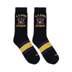 Flat lay of two black crew socks showing the U.S. Navy Veteran eagle design on the leg and yellow and blue foot stripes.