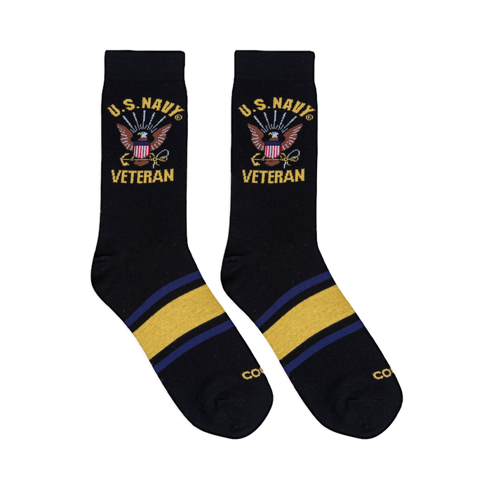 Flat lay of two black crew socks showing the U.S. Navy Veteran eagle design on the leg and yellow and blue foot stripes.