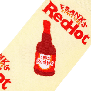 A yellow sock with a red bottle of Frank's RedHot sauce on it.