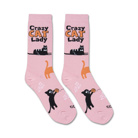 pink crew socks feature a playful pattern of black cats playing with balls of yarn. great for cat lovers. women's size.   