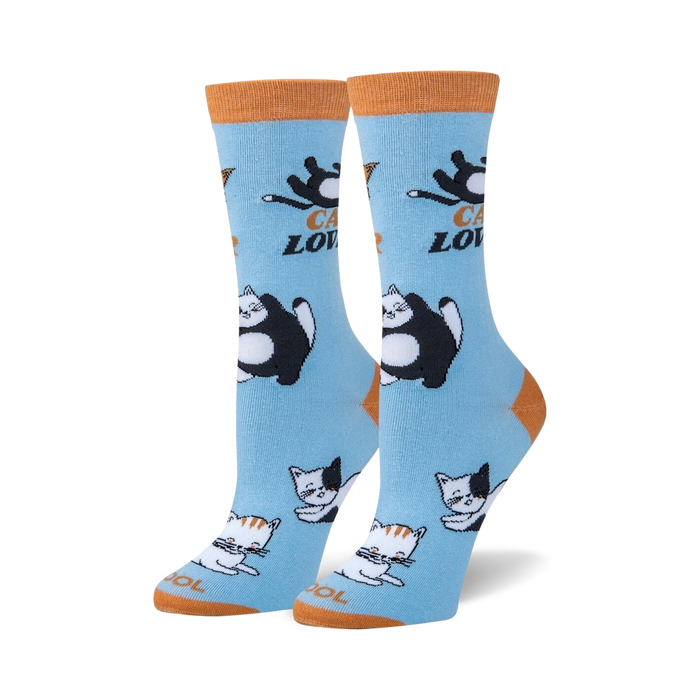 blue crew socks with allover pattern of cartoon cats in black, white, and orange.   