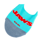 Lifestyle product shot showing a pair of 'Jaws' no-show socks laid flat, displaying both the logo and shark designs.