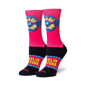 pink crew socks with wheel of fortune logo on front, yellow stars, and black toe and heel.   