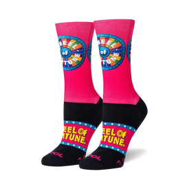 pink crew socks with wheel of fortune logo on front, yellow stars, and black toe and heel.   