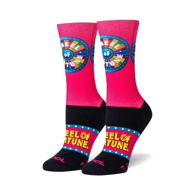 pink crew socks with wheel of fortune logo on front, yellow stars, and black toe and heel.   