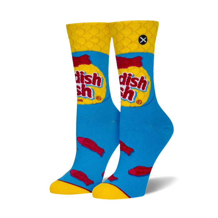 Pair of crew socks showcasing a Swedish Fish candy design. Blue background with red fish and yellow cuffs, featuring the Swedish Fish logo.