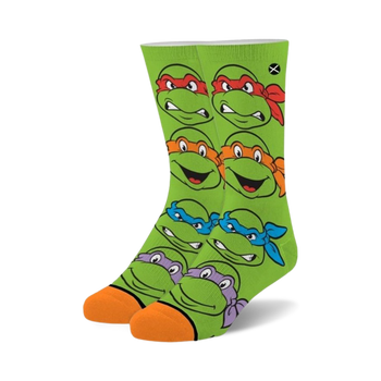 green crew socks for kids featuring a pattern of teenage mutant ninja turtles faces.  