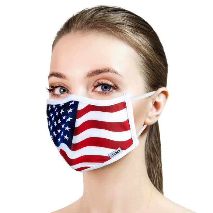 A young woman is wearing a white and red face mask with a blue background. The mask has a pattern of white stars and red and white stripes.