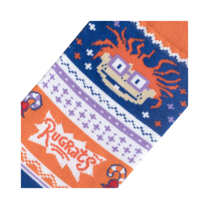Close-up detail shot of the Chuckie Ugly Sweater socks, highlighting the Rugrats logo and Chuckie's face.