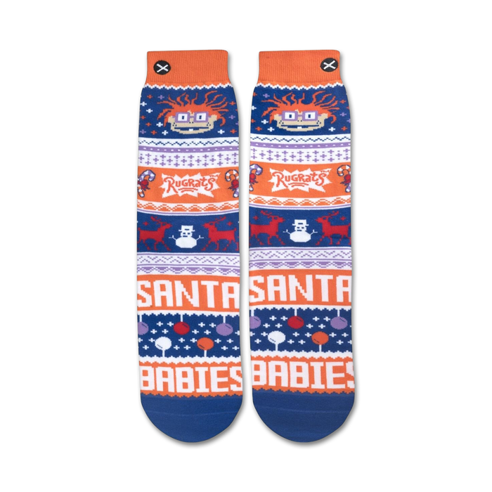 A pair of blue and orange socks with a pattern of Rugrats characters, candy canes, and snowflakes. The words 