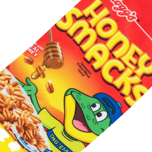 A red sock with a picture of the cereal box for Honey Smacks on it. The cartoon frog mascot is shown on the front of the box, along with the cereal and a bowl of milk. The text on the box says 