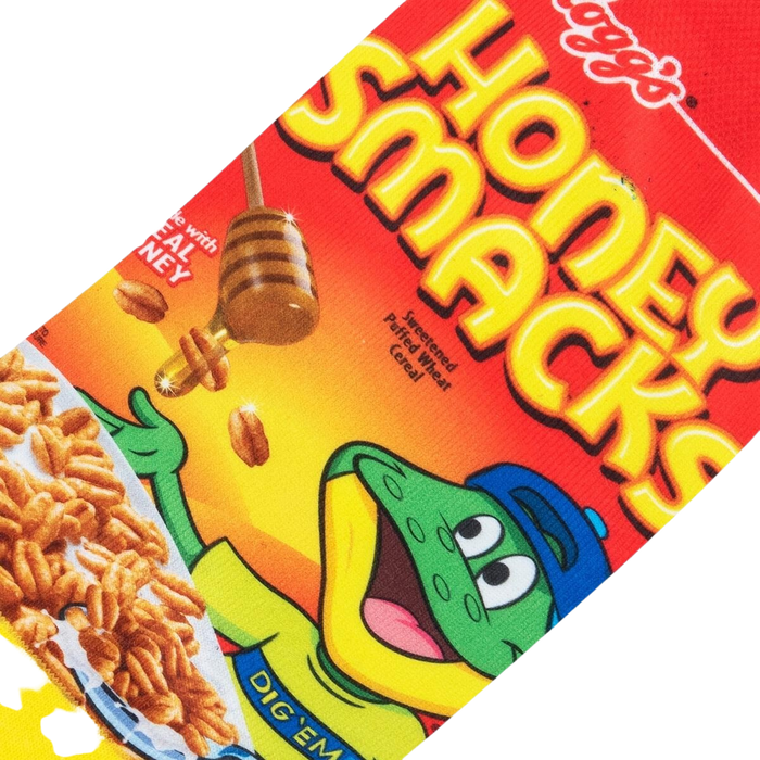 A red sock with a picture of the cereal box for Honey Smacks on it. The cartoon frog mascot is shown on the front of the box, along with the cereal and a bowl of milk. The text on the box says 