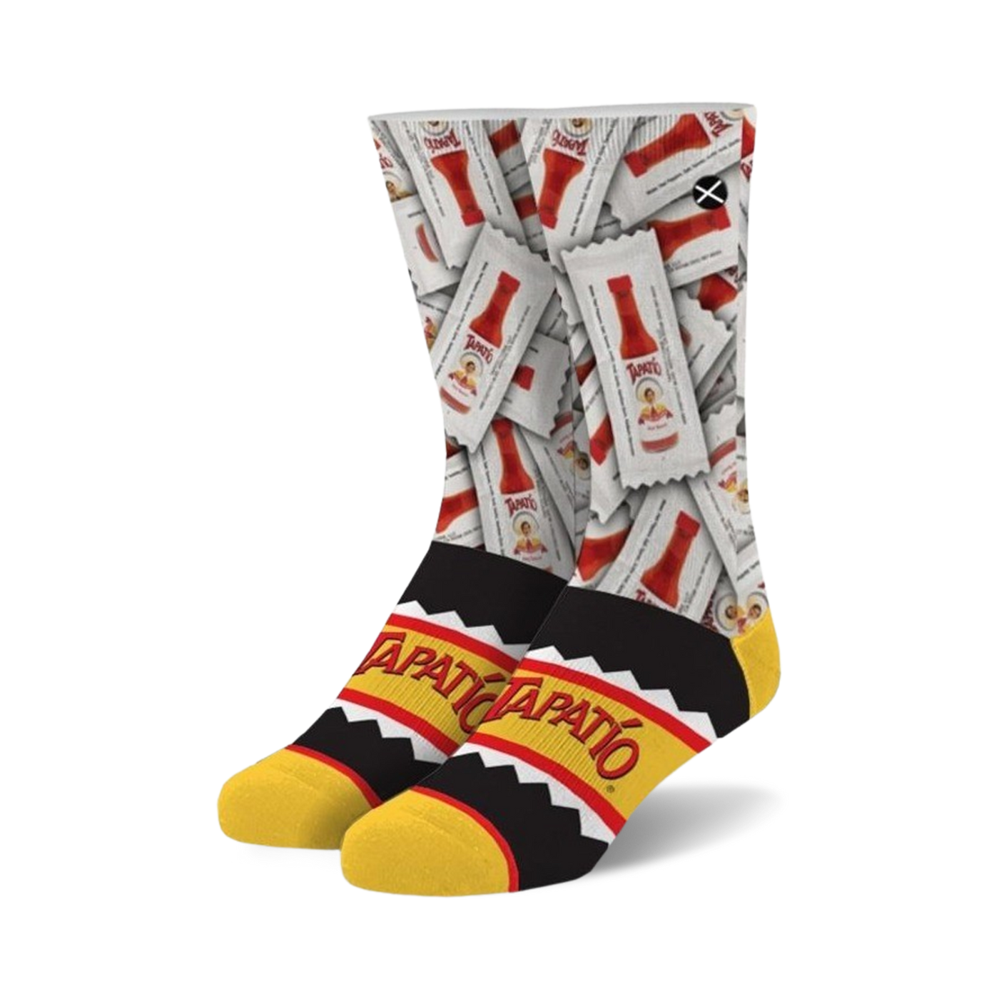 A pair of crew socks showcasing a repeating pattern of Tapatio hot sauce packets on a white background. The cuff features a black and yellow Tapatio logo.