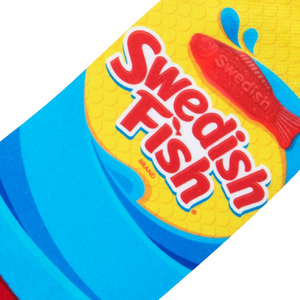 A red Swedish Fish candy on a blue background with yellow text that reads: 