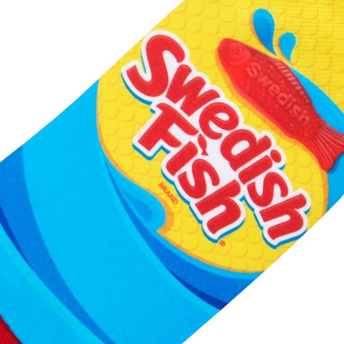 A red Swedish Fish candy on a blue background with yellow text that reads: 