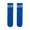 Pair of blue crew socks with an Art Deco design. The socks feature a woman's face with gold eyes and red lips, along with the text 'The Great Gatsby'.
