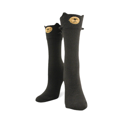 Tall black socks with a bear face at the top cuff featuring a tan muzzle and small 3D ears sticking out from the edges.