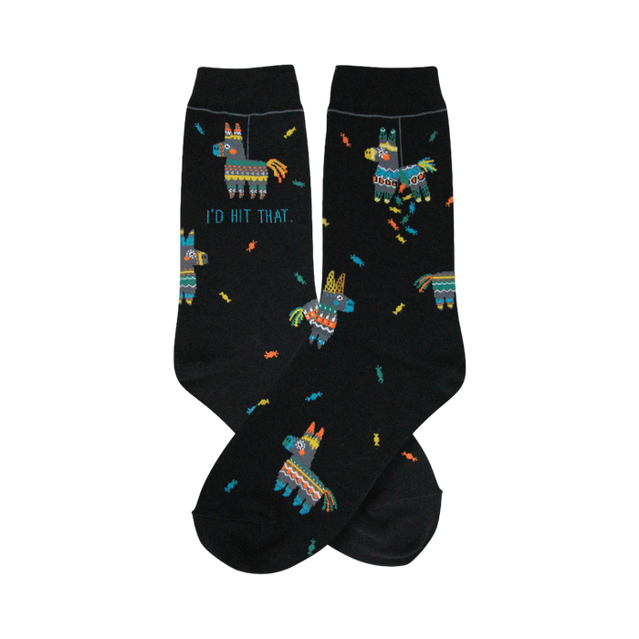A pair of black crew socks with a fun pattern. The design includes colorful piñatas and the phrase 