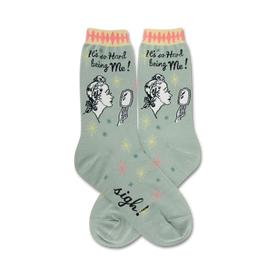 green crew socks with an illustration of a woman looking in a mirror and saying it's hard being me.  the text sigh can be seen on the foot