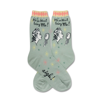 green crew socks with an illustration of a woman looking in a mirror and saying it's hard being me.  the text sigh can be seen on the foot