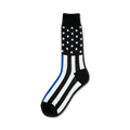 Crew socks in black and white with a thin blue line and an American flag design on the upper part of the sock.
