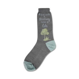 womens reading novelty sock. blue sock with "where there is reading there is life" in blue. reading book person under green tree on blue toe.  