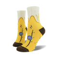 Pair of yellow banana-themed non-skid slipper socks. Brown heel and toe. Features small blue logo that says 'Top Banana #4011'.