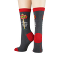 Pair of grey and red 'Realtor' socks on a model's feet.