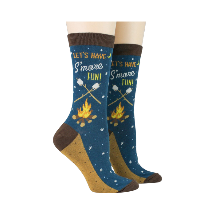 Pair of 'Let's Have S'more Fun!' socks on a model's feet against a black background.