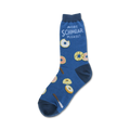 A blue crew sock with illustrated donuts and the text 'More Schmear Please!' in white.  Donuts are in pink, yellow, and brown.