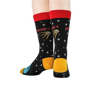 A pair of black socks with a red cuff. The socks are decorated with a pattern of white stars, a yellow and blue globe, and a red and yellow satellite. The word 