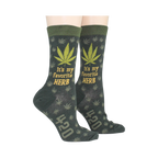 Lifestyle shot of a person wearing the green marijuana socks, showcasing how they look when worn.