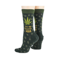 Close-up flatlay showcasing the detail of the marijuana leaf socks, highlighting the 'It's my favorite herb' text and '420' detail.