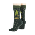 Close-up flatlay showcasing the detail of the marijuana leaf socks, highlighting the 'It's my favorite herb' text and '420' detail.
