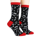 Pair of 'Dancing Notes' socks on a model's feet, showcasing the full design.