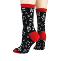 Back view of 'Dancing Notes' socks on a model's feet, showing the red cuff detail.