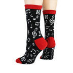 Back view of 'Dancing Notes' socks on a model's feet, showing the red cuff detail.