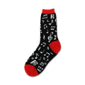 Close-up of a black crew sock with white musical notes and a red cuff.  'Dancing Notes' sock design.